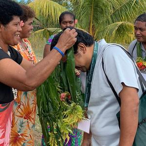 Local women welcomed participants with floral necklaces