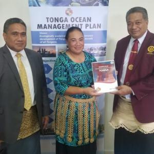 Hon Tei receives copy of the Tonga Marine Atlas from Director of Environment Ms Atelaite Lupe Matoto as the Chief Executive Officer Environment (MEIDECC) Mr Paula Ma’u looks on